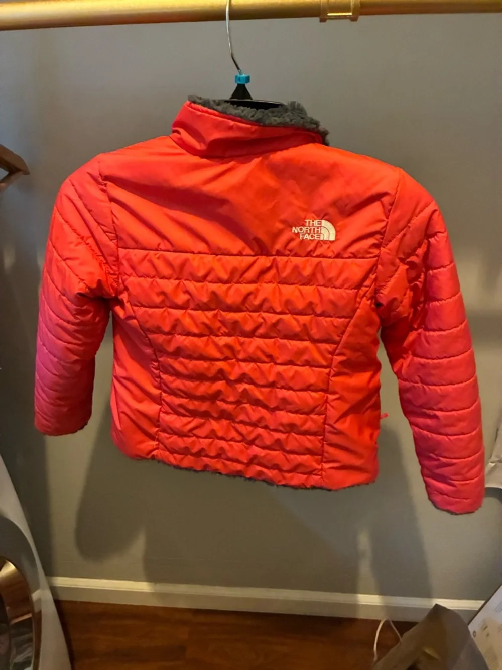 The North Face reversible Kids coral Jacket with Charcoal Fleece Interior.